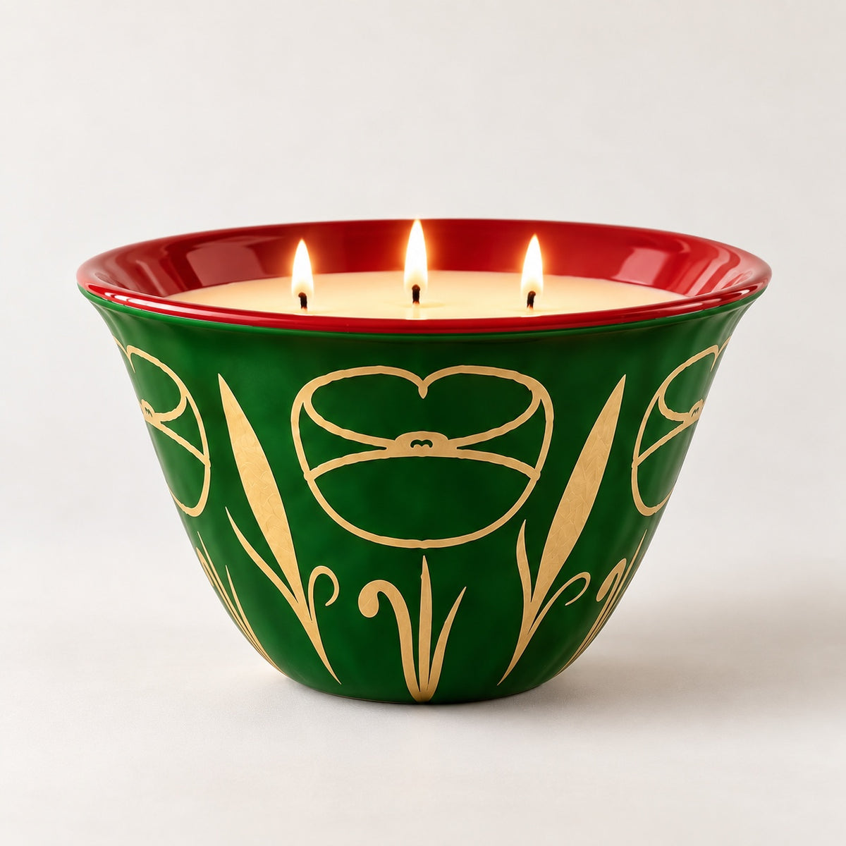 Coqlipot® 180 Festive Jewel Candle Edition, Émeraude — emerald-green cement vessel, ruby-red rim, gold poppy motif, lit three-wick soy-blend wax candle